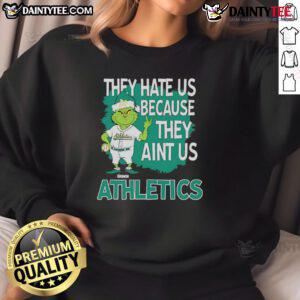 Awesome Athletics Grinch Christmas sweatshirt featuring 'They Hate Us Ain't Us' design, perfect for holiday cheer.