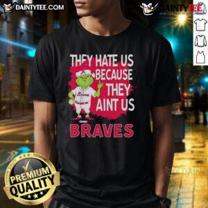 Alt Text: Awesome Atlanta Braves Grinch Christmas T-Shirt featuring 'They Hate Us Ain't Us' design, perfect for holiday cheer.