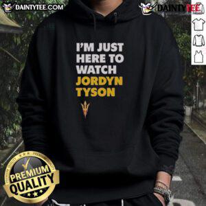 Awesome Jordyn Tyson I'm Just Here To Watch Hoodie displayed on a mannequin in a trendy urban setting.