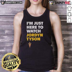 Alt Text: Jordyn Tyson wearing an 'I'm Just Here to Watch' tank top, showcasing a casual and stylish summer look.
