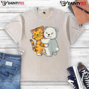 Alt Text: Cute cat and bear hugging in an adorable cartoon design on a washed t-shirt, showcasing animal friendship.