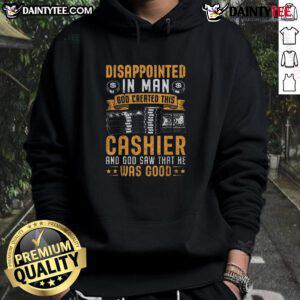 Funny cashier wearing 'God created this cashier' hoodie, looking disappointed at a customer in a grocery store.