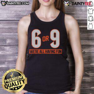 Group of friends wearing 'Good 6 or 9 We're All Having Fun' tank tops, enjoying a sunny day outdoors.