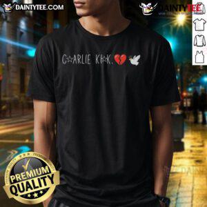 Happy Charlie Kirk wearing a Broken Heart Dove T-Shirt, showcasing a vibrant design and positive message for fans.