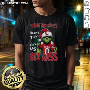 Awesome Grinch Ole Miss Rebels football t-shirt with 'They Hate Us Because They Ain't Us' slogan in vibrant design.