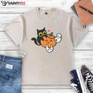 Cute cat with pumpkins and ghosts on a washed t-shirt, perfect for Halloween and cat lovers.