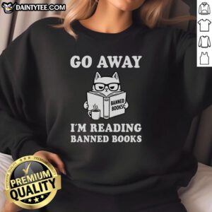 Alt Text: Adorable cat wearing a 'Go Away I'm Reading Banned Books' sweatshirt, perfect for book lovers and cat enthusiasts.