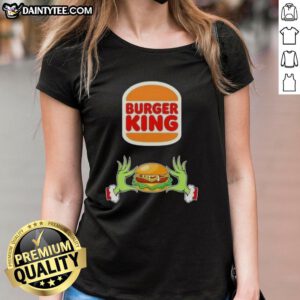 Alt Text: Good Grinch hands holding a Burger King logo on a Merry Christmas ladies tee, festive holiday apparel.