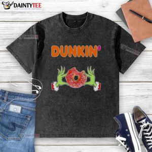Good Grinch hands holding a Dunkin' donut on a Merry Christmas washed t-shirt, perfect for holiday cheer.