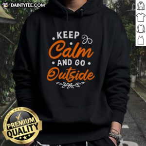 Happy 'Keep Calm and Go Outside' hoodie displayed on a wooden background, perfect for outdoor enthusiasts.
