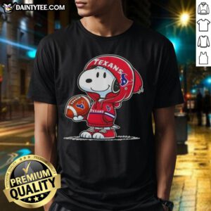 Alt Text: Happy Peanuts Snoopy in a Houston Texans hoodie smiles at fans on a vibrant t-shirt, showcasing team spirit.