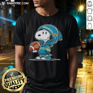 Alt Text: Happy Peanuts Snoopy in a hoodie, smiling at fans in a Jacksonville Jaguars T-shirt, perfect for NFL enthusiasts.