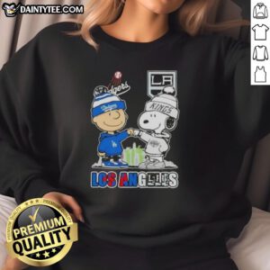 Awesome Charlie Brown fist bump with Snoopy, featuring Los Angeles skyline and Dodgers x Kings sweatshirt design.