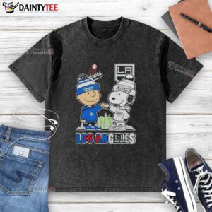 Alt Text: Awesome Charlie Brown fist bump with Snoopy, Los Angeles skyline, Dodgers and Kings logo on a washed t-shirt.