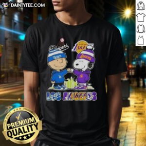 Awesome Charlie Brown fist bump with Snoopy against Los Angeles skyline, showcasing Dodgers and Lakers sports T-shirt.