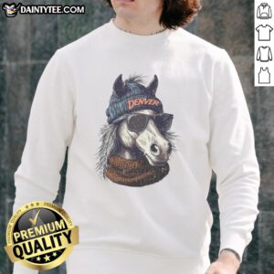 Denver Broncos mascot wearing a beanie and sunglasses, showcasing team spirit in a cozy sweatshirt.
