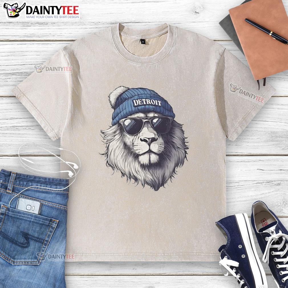 Detroit Lions mascot in a beanie and sunglasses, showcasing a stylish washed t-shirt at a football event.