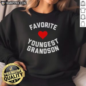 Young boy wearing an Awesome Favorite Youngest Grandson heart sweatshirt, smiling joyfully outdoors.