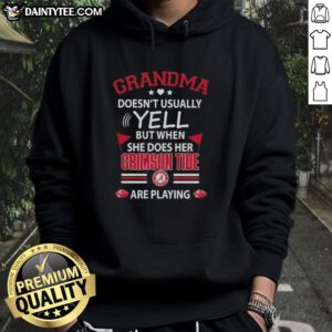 Awesome grandma in a cozy Alabama Crimson Tide hoodie, cheering enthusiastically during the game.