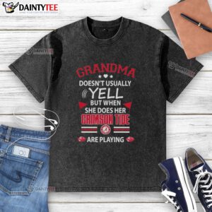 Awesome grandma in Alabama Crimson Tide shirt, excitedly cheering during a game, showcasing her team spirit.