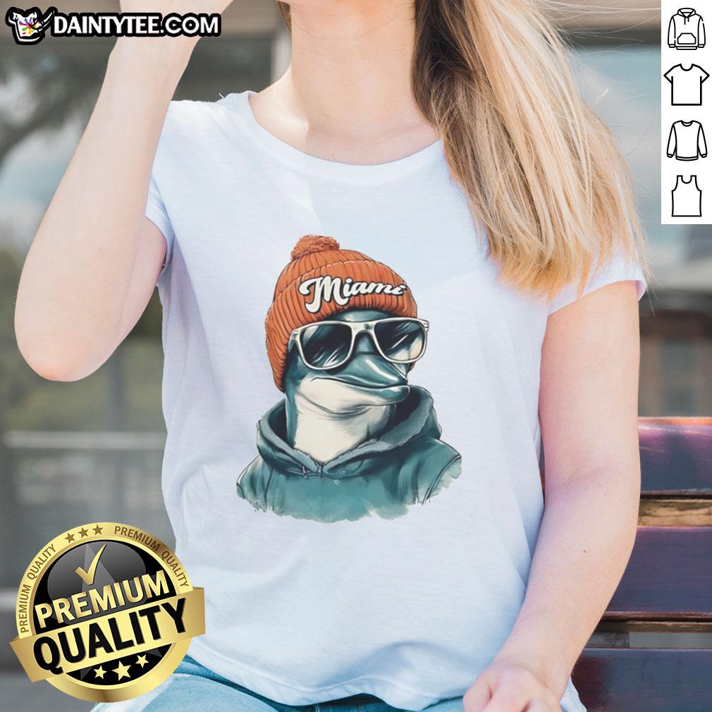 Miami Dolphins mascot in a beanie and sunglasses, showcasing team spirit on a stylish ladies tee.