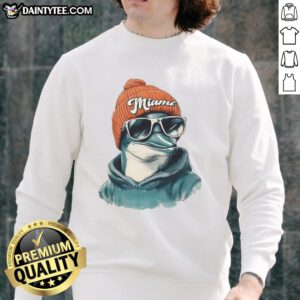 Awesome Miami Dolphins mascot in a beanie and sunglasses, wearing a sweatshirt, showcasing team spirit and fun.