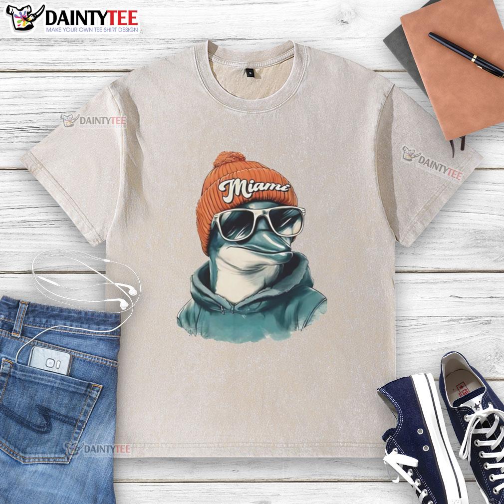 Miami Dolphins mascot in a beanie and sunglasses, showcasing team spirit in a washed t-shirt at a game.