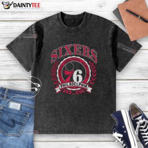 Retro washed t-shirt featuring the Philadelphia 76ers logo framed by a laurel wreath, perfect for NBA fans.