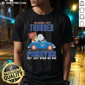 Alt Text: Snoopy and Charlie Brown driving a car on an Oklahoma City Thunder T-shirt, celebrating team spirit and loyalty.
