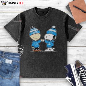Cute Detroit Lions Snoopy and Charlie Brown best friends graphic on a washed t-shirt, perfect for fans.