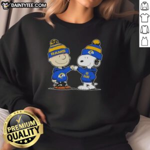 Cute Peanuts Charlie Brown and Snoopy fist bump in Los Angeles Rams football sweatshirt, perfect for fans and cozy wear.