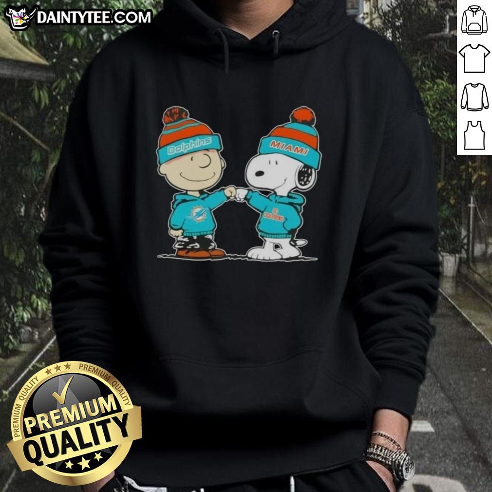 Cute Peanuts Charlie Brown and Snoopy fist bump in Miami Dolphins football hoodie, perfect for fans and collectors.