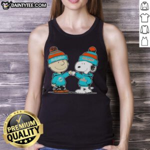 Adorable Charlie Brown and Snoopy fist bump on a Miami Dolphins football tank top, perfect for Peanuts fans.