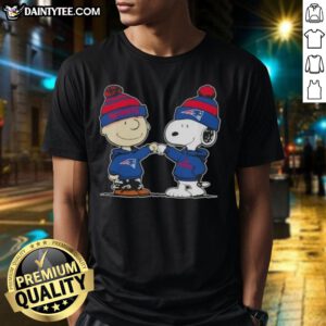 Charlie Brown and Snoopy fist bump on New England Patriots football T-Shirt, perfect for fans and Peanuts lovers.