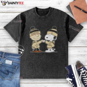 Alt Text: Cute Peanuts Charlie Brown and Snoopy fist bump in New Orleans Saints football washed t-shirt design.