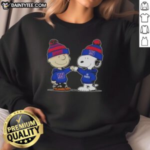 Adorable Charlie Brown and Snoopy fist bump in New York Giants football sweatshirt, perfect for Peanuts fans.