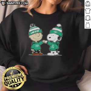 Charlie Brown and Snoopy fist bump in a Cute Peanuts sweatshirt featuring New York Jets football design.