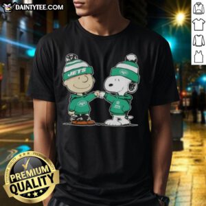 Alt Text: Cute Peanuts Charlie Brown and Snoopy fist bump on a New York Jets football t-shirt, perfect for fans.