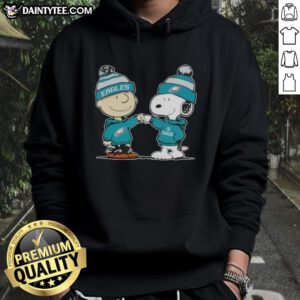 Alt Text: Cute Peanuts Charlie Brown fist bumping Snoopy in a Philadelphia Eagles football hoodie, perfect for fans.