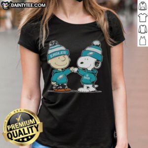 Alt Text: Cute Peanuts Charlie Brown and Snoopy fist bump in Philadelphia Eagles football ladies tee design.
