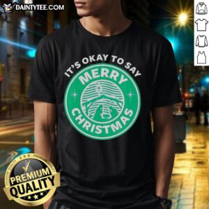 Alt Text: Funny It's Okay To Say Merry Christmas logo T-Shirt featuring festive graphics and a playful holiday message.