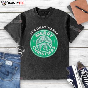 Funny 'It's Okay To Say Merry Christmas' logo on a washed t-shirt, perfect for festive holiday celebrations.