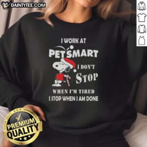 Funny Snoopy Christmas sweatshirt featuring the phrase 'I work at PetSmart, I dont stop when Im tired'.
