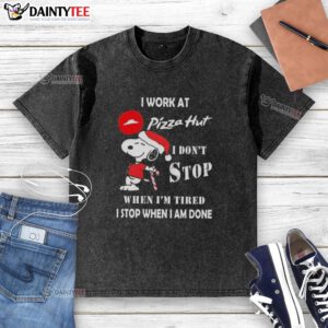 Funny Snoopy Christmas t-shirt design featuring 'I Work At Pizza Hut, I Don't Stop When I'm Tired' slogan.