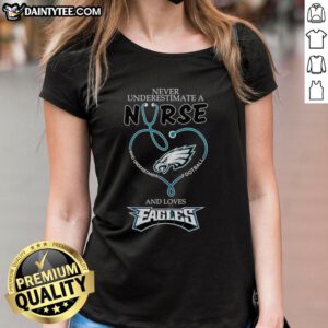 Hot ladies tee featuring 'Never Underestimate a Nurse Who Loves Football' design, perfect for Philadelphia Eagles fans.