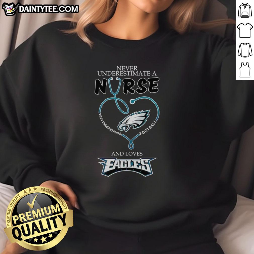 Hot sweatshirt featuring 'Never Underestimate a Nurse Who Loves Football' design for Philadelphia Eagles fans.