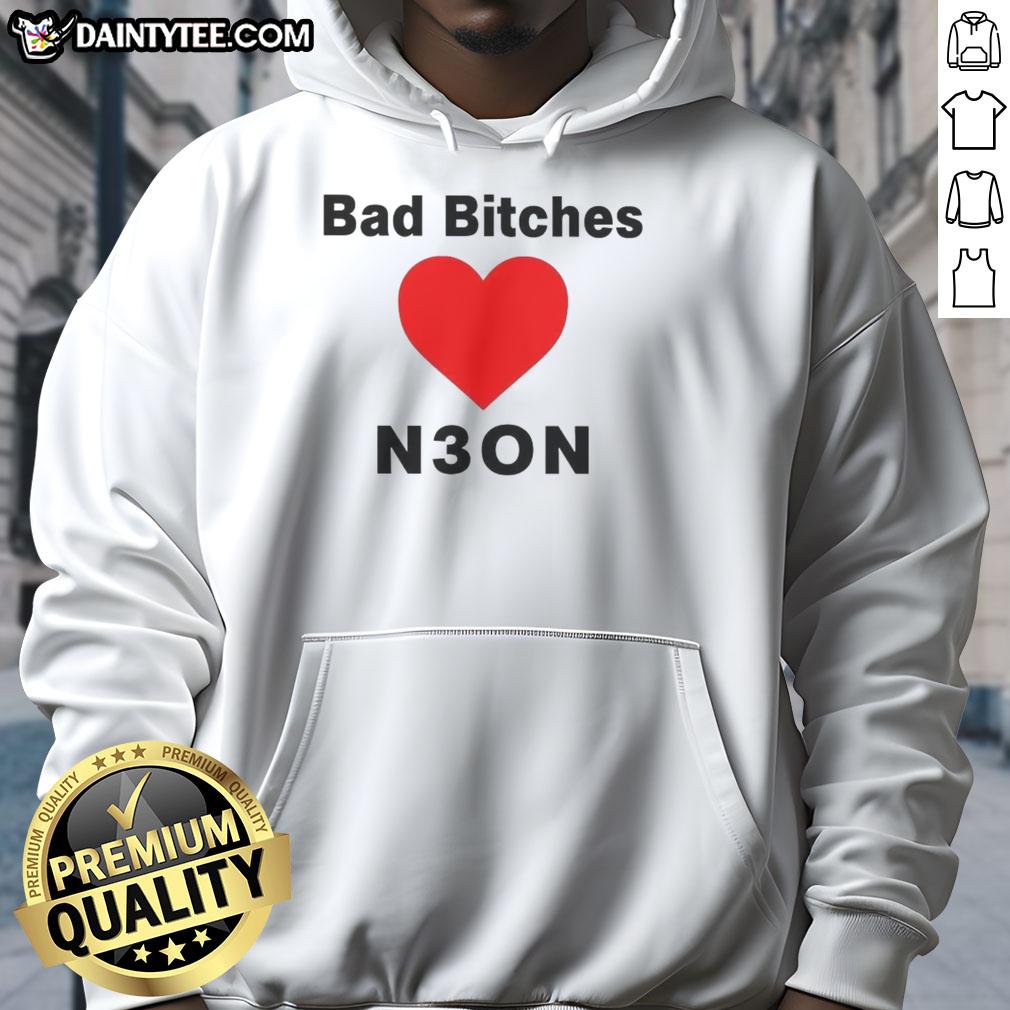 Stylish woman wearing a 'Nice Bad Bitches Love Neon Hoodie' in a vibrant urban setting, showcasing modern street fashion.