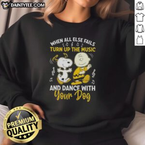 Snoopy and Charlie Brown on a sweatshirt, with the quote 'When all else fails, turn up the music and dance with your dog.'