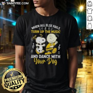 Alt Text: Snoopy and Charlie Brown graphic on a T-shirt with the phrase 'When All Else Fails, Turn Up The Music and Dance with Your Dog.'