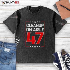 Premium Clean Up On Aisle 47 washed t-shirt displayed on a wooden surface, showcasing its soft fabric and vibrant design.